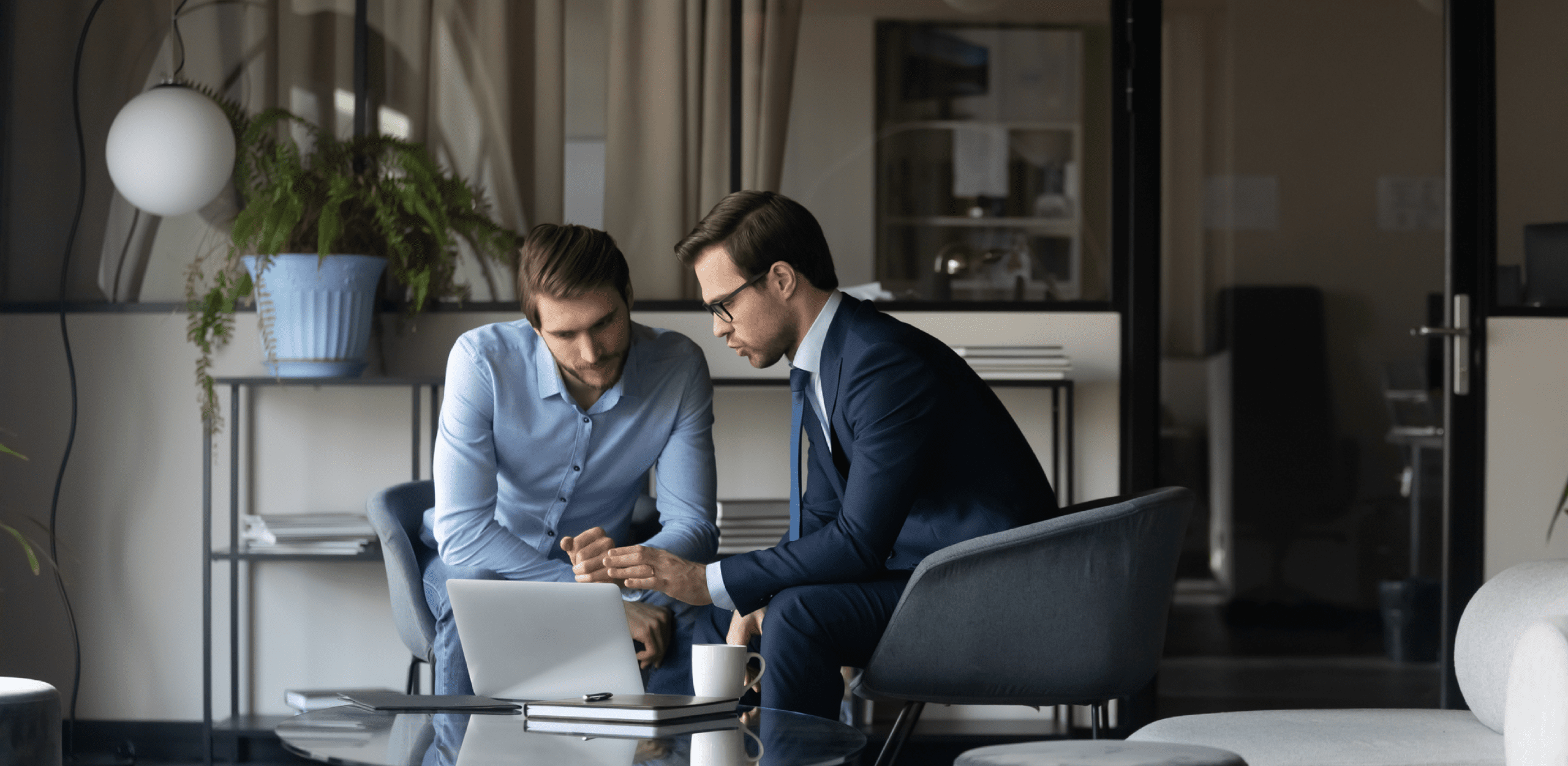 Two men in suits are working.